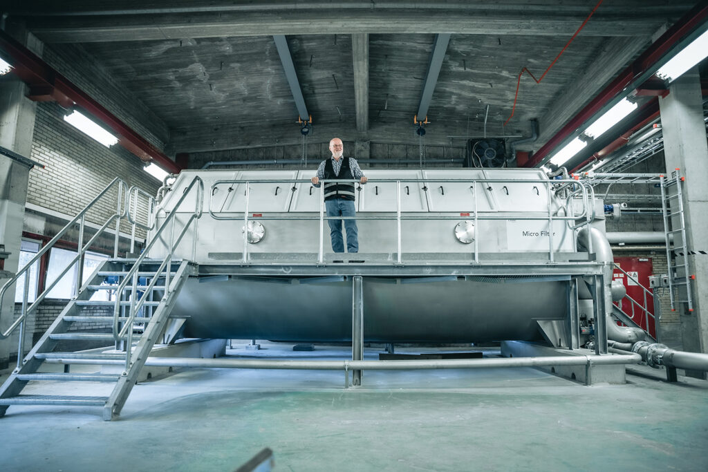 Man standing in front of huge water filtration system