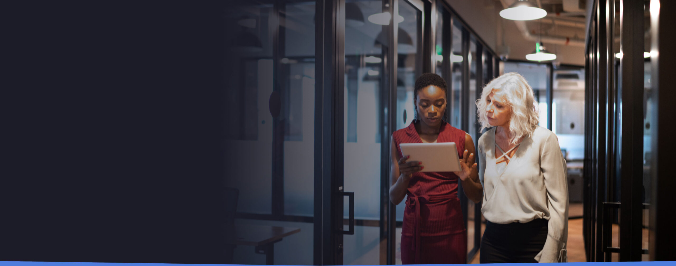 Two female colleagues looking over tablet