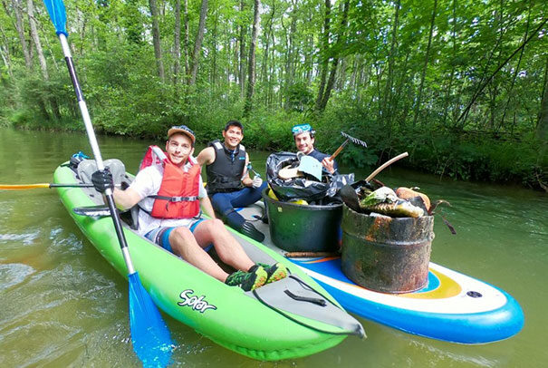 Crane volunteers in kayaks collecting trash from river