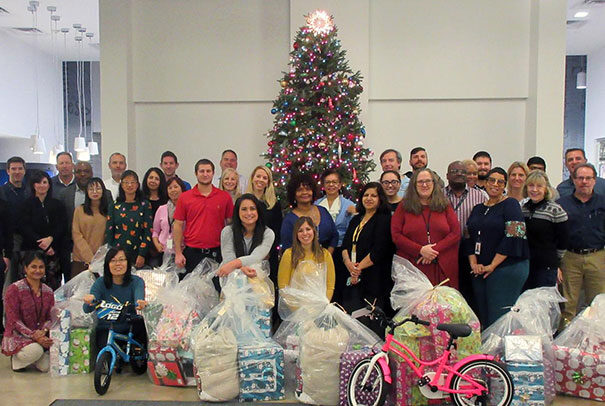 Crane team in front of Christmas tree with donations