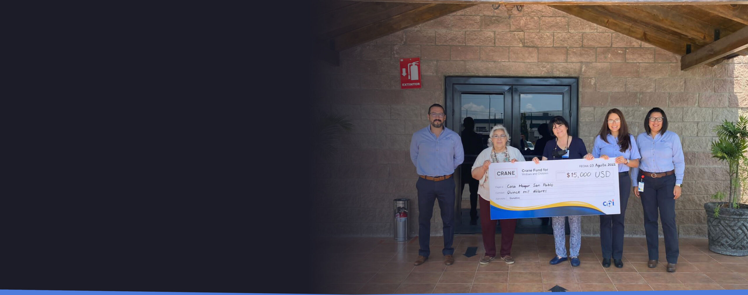 Crane employees holding oversized check